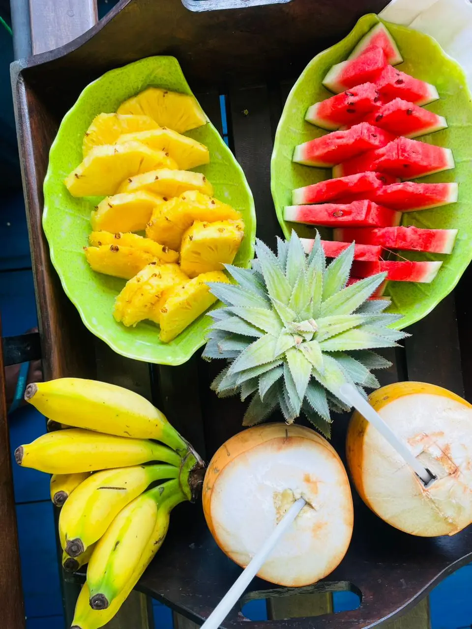 Overhead view of pineapple, watermelon, banana and king coconut on the safari boat